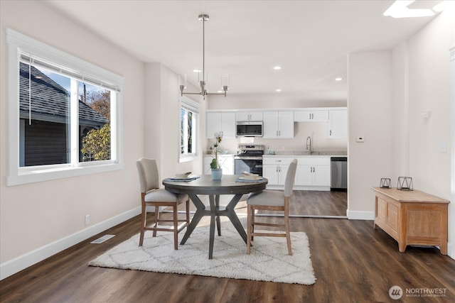 dining space with visible vents, a notable chandelier, recessed lighting, baseboards, and dark wood-style flooring