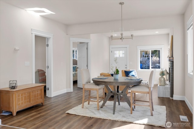 dining room with dark wood finished floors and baseboards