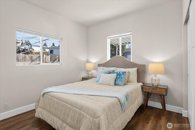 bedroom featuring baseboards and wood finished floors