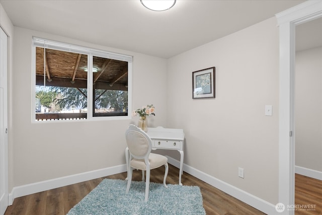 office space with baseboards and wood finished floors