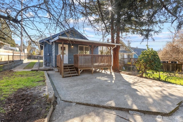 rear view of house with french doors, covered porch, fence private yard, and a gate