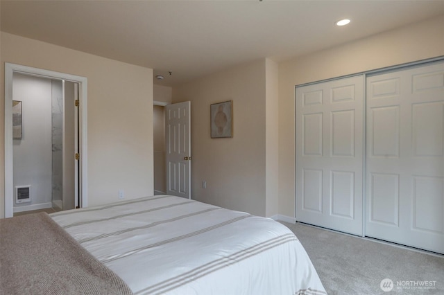 carpeted bedroom featuring visible vents, baseboards, recessed lighting, a closet, and ensuite bathroom