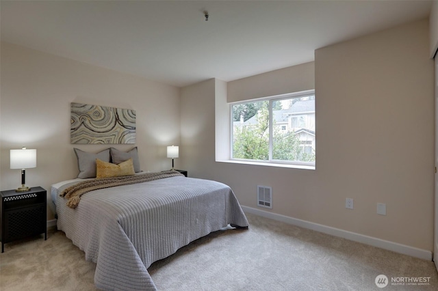 bedroom with visible vents, baseboards, and light colored carpet