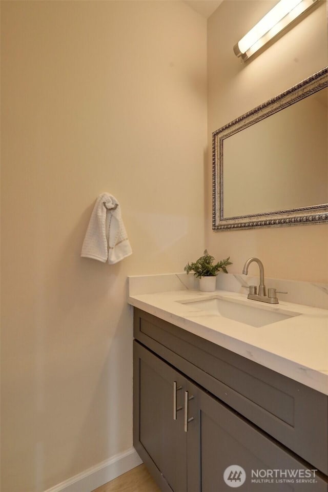 bathroom with vanity and baseboards