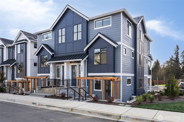 view of front of home featuring board and batten siding, metal roof, and a standing seam roof