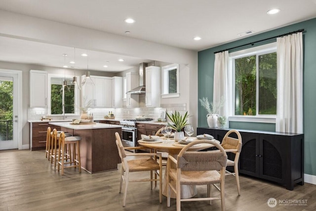 dining area with recessed lighting, a healthy amount of sunlight, and light wood finished floors