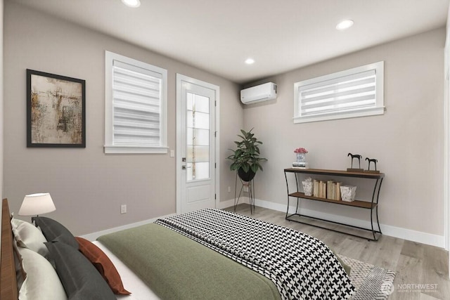 bedroom featuring an AC wall unit, multiple windows, wood finished floors, and recessed lighting