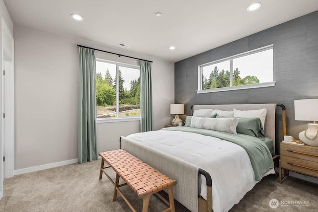 bedroom featuring light carpet, visible vents, recessed lighting, and baseboards