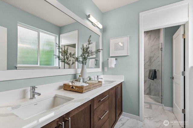 bathroom featuring a shower stall, baseboards, marble finish floor, and a sink