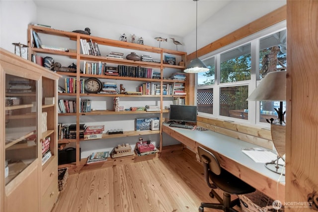 office space featuring wood finished floors and built in study area