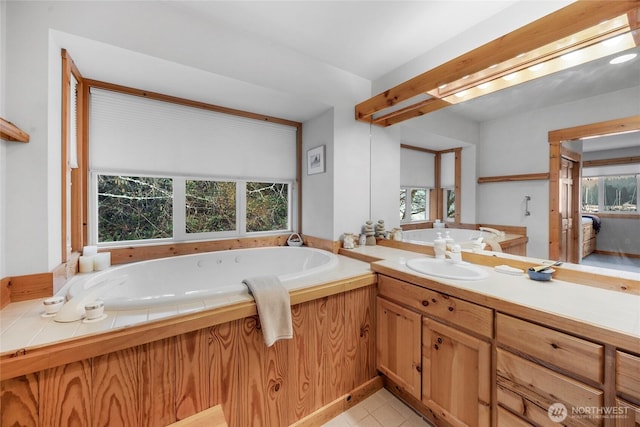 full bath featuring vanity, a garden tub, and tile patterned floors