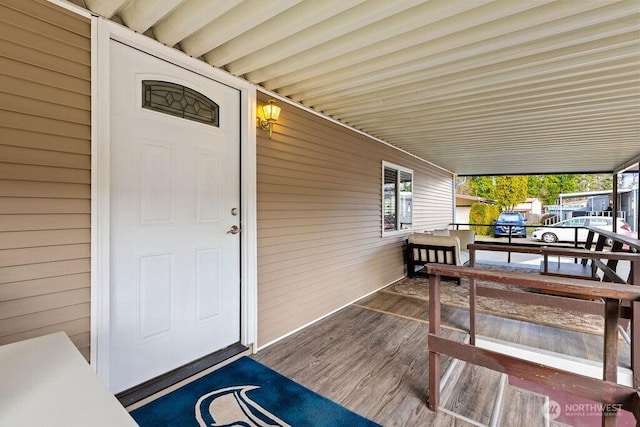 wooden terrace with a carport and covered porch