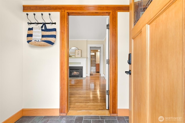 corridor featuring baseboards and wood finished floors