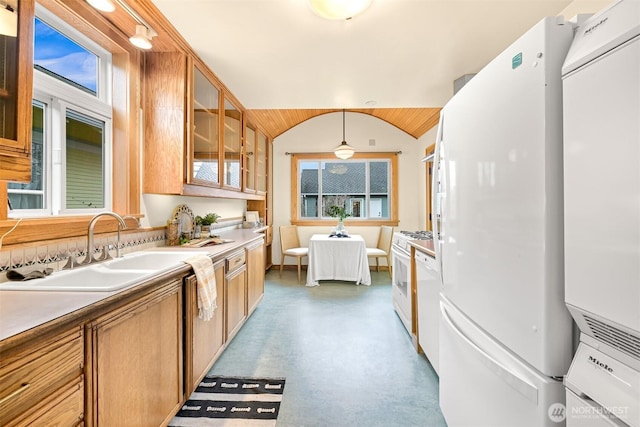 kitchen featuring white appliances, concrete floors, lofted ceiling, a sink, and glass insert cabinets