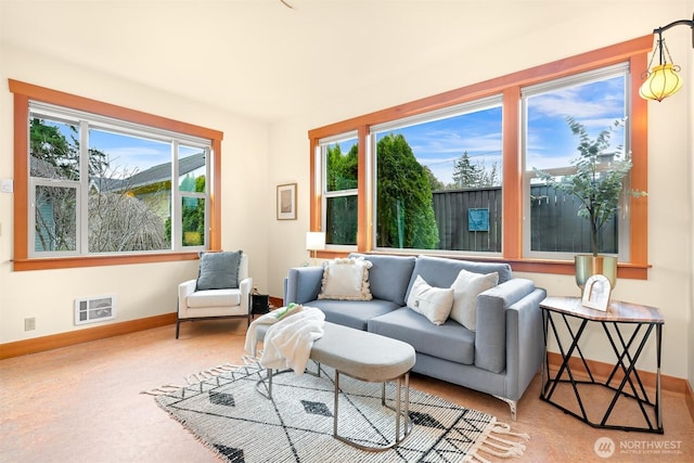 living area with baseboards and carpet floors