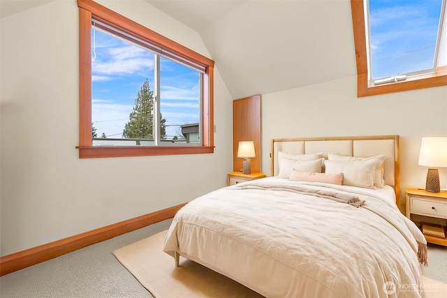 bedroom with carpet flooring, baseboards, and vaulted ceiling