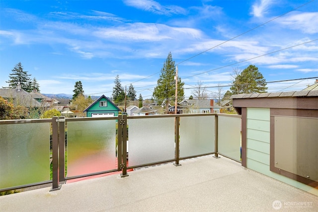 view of patio featuring a residential view, a balcony, and a gate