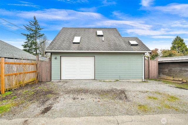 detached garage featuring fence