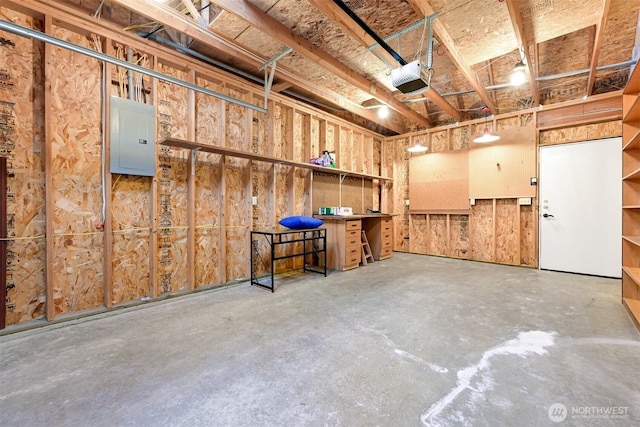 garage with electric panel and a garage door opener