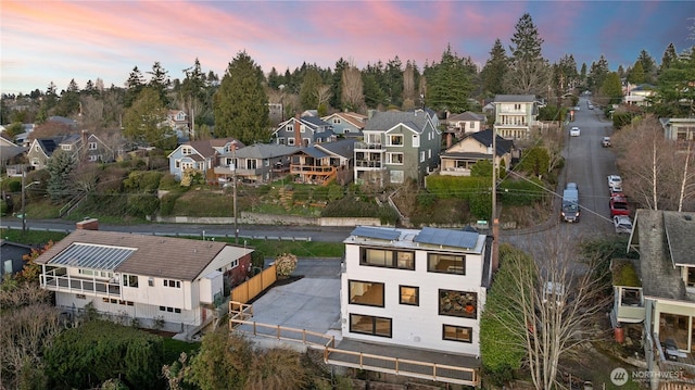 aerial view at dusk featuring a residential view