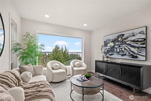 living area featuring recessed lighting, baseboards, and wood finished floors