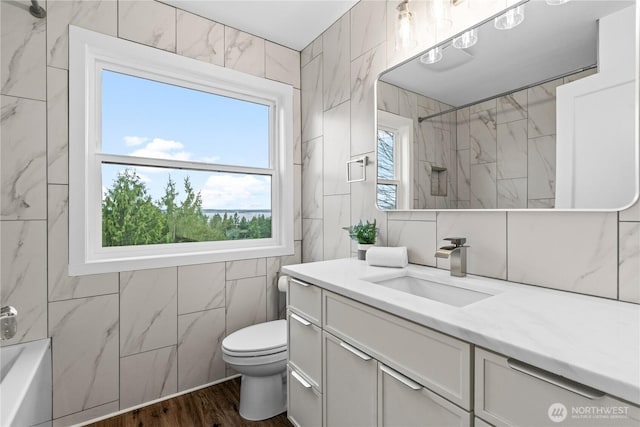 full bath featuring a shower and tile walls