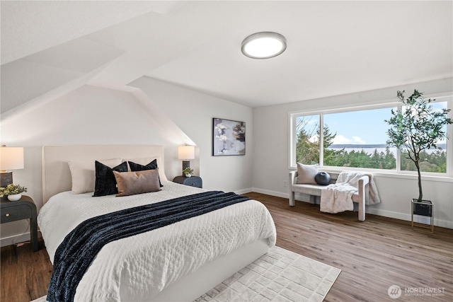 bedroom with wood finished floors and baseboards