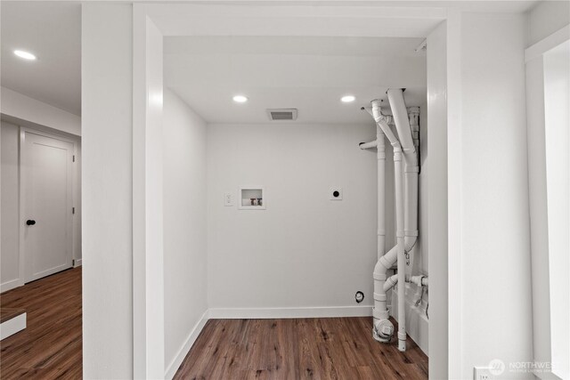 laundry area featuring electric dryer hookup, visible vents, wood finished floors, baseboards, and hookup for a washing machine