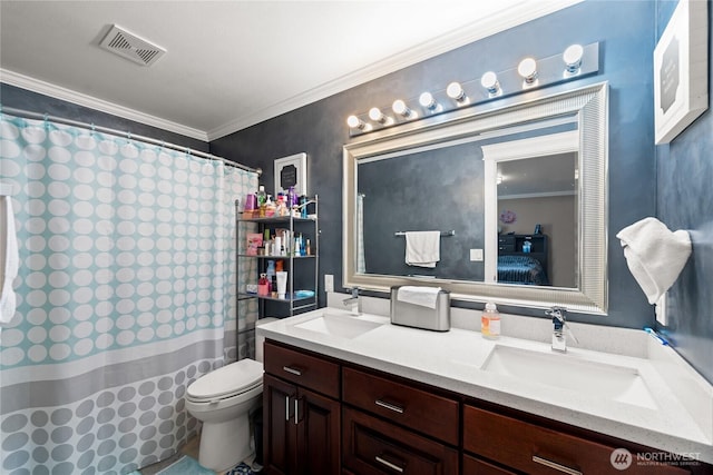 ensuite bathroom featuring visible vents, crown molding, and a sink