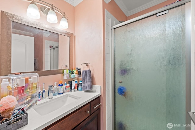 full bathroom featuring vanity, crown molding, and a stall shower