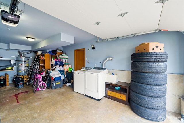 garage with washing machine and dryer, secured water heater, and a garage door opener