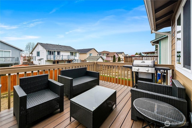 wooden terrace with a residential view, an outdoor living space, and area for grilling