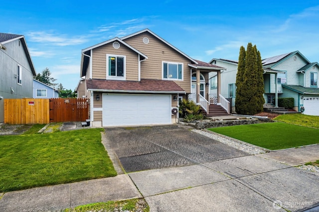 view of front facade featuring a shingled roof, fence, a front yard, a garage, and driveway