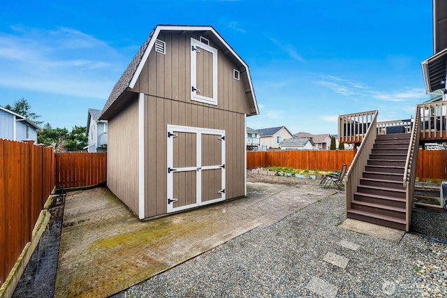 view of shed featuring a fenced backyard and stairs