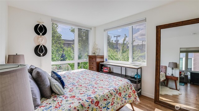 bedroom featuring baseboards and wood finished floors