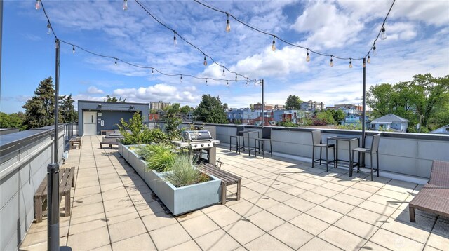 view of patio featuring a city view, a vegetable garden, and a grill