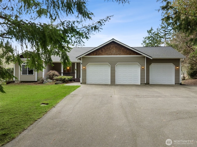 view of front facade with an attached garage, concrete driveway, and a front lawn