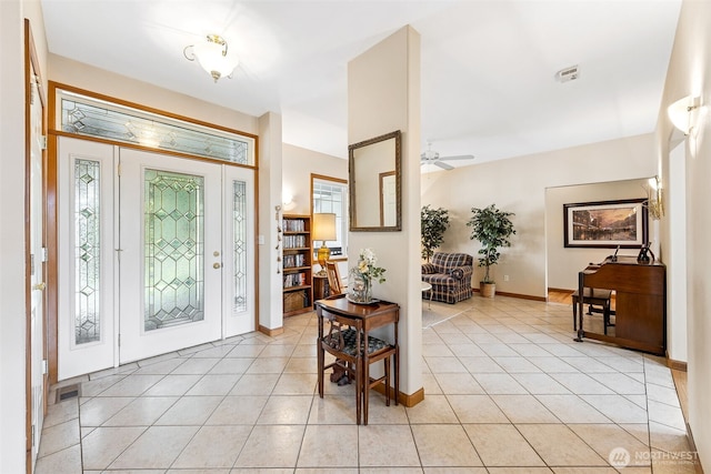 entrance foyer featuring ceiling fan, visible vents, baseboards, and light tile patterned flooring