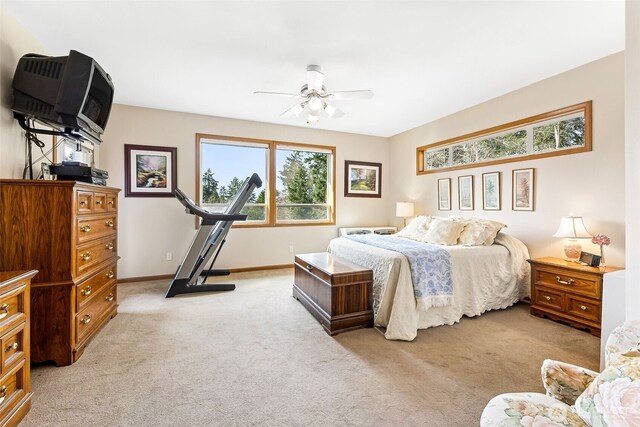 bedroom with ceiling fan, baseboards, and light carpet