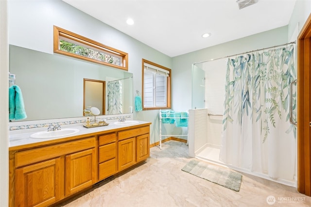 bathroom with double vanity, visible vents, a shower with shower curtain, and a sink