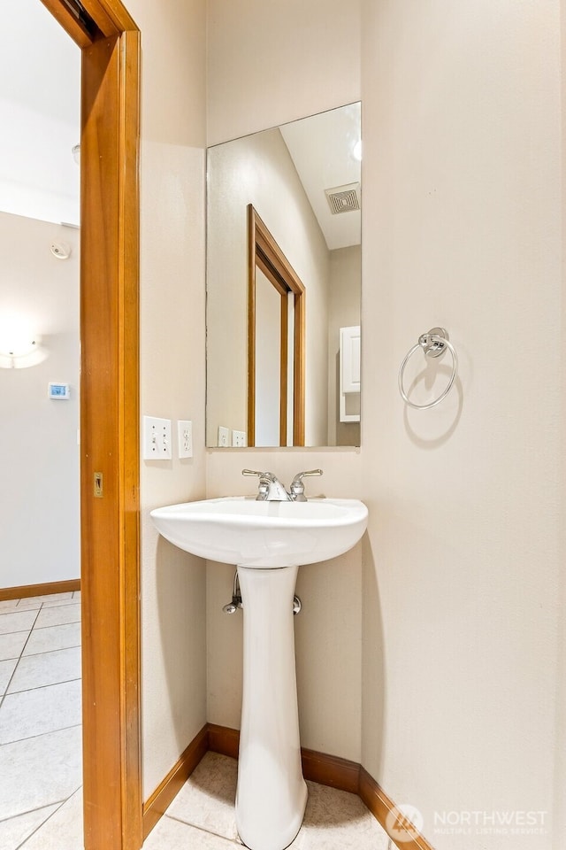 bathroom with tile patterned flooring, visible vents, baseboards, and a sink