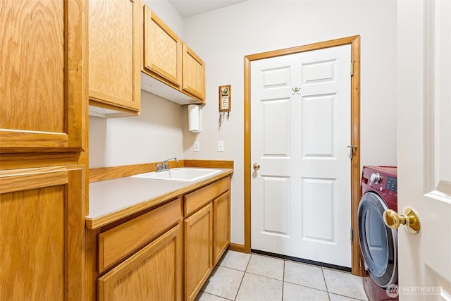 washroom with washer / dryer, light tile patterned flooring, cabinet space, and a sink