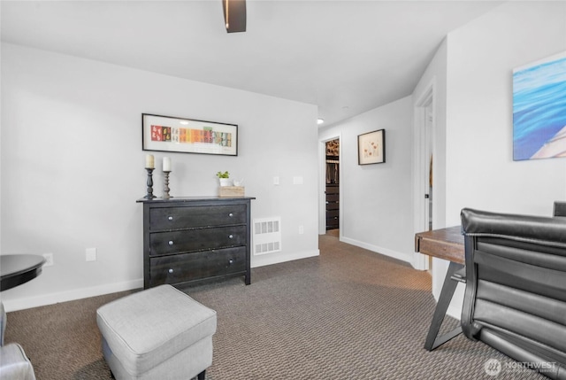 living area featuring baseboards, visible vents, carpet floors, and ceiling fan