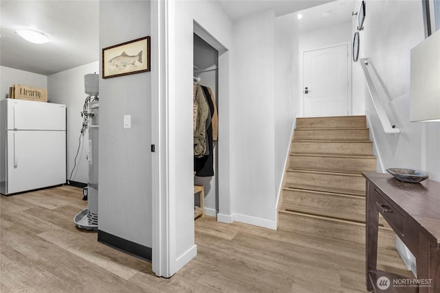 stairs with baseboards and wood finished floors