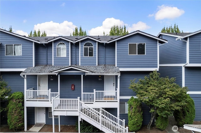 view of front of home with a porch and stairway