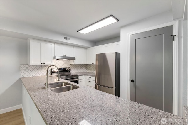 kitchen with tasteful backsplash, visible vents, under cabinet range hood, appliances with stainless steel finishes, and a sink