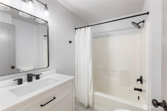 full bathroom featuring toilet, vanity, and shower / bathtub combination with curtain