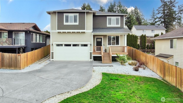 traditional-style home featuring fence, covered porch, concrete driveway, a front yard, and a garage