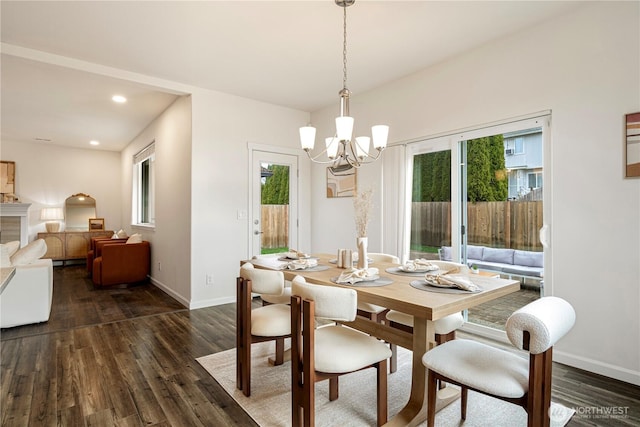 dining area with recessed lighting, an inviting chandelier, dark wood-type flooring, and baseboards