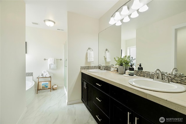 bathroom featuring visible vents, baseboards, marble finish floor, and a sink